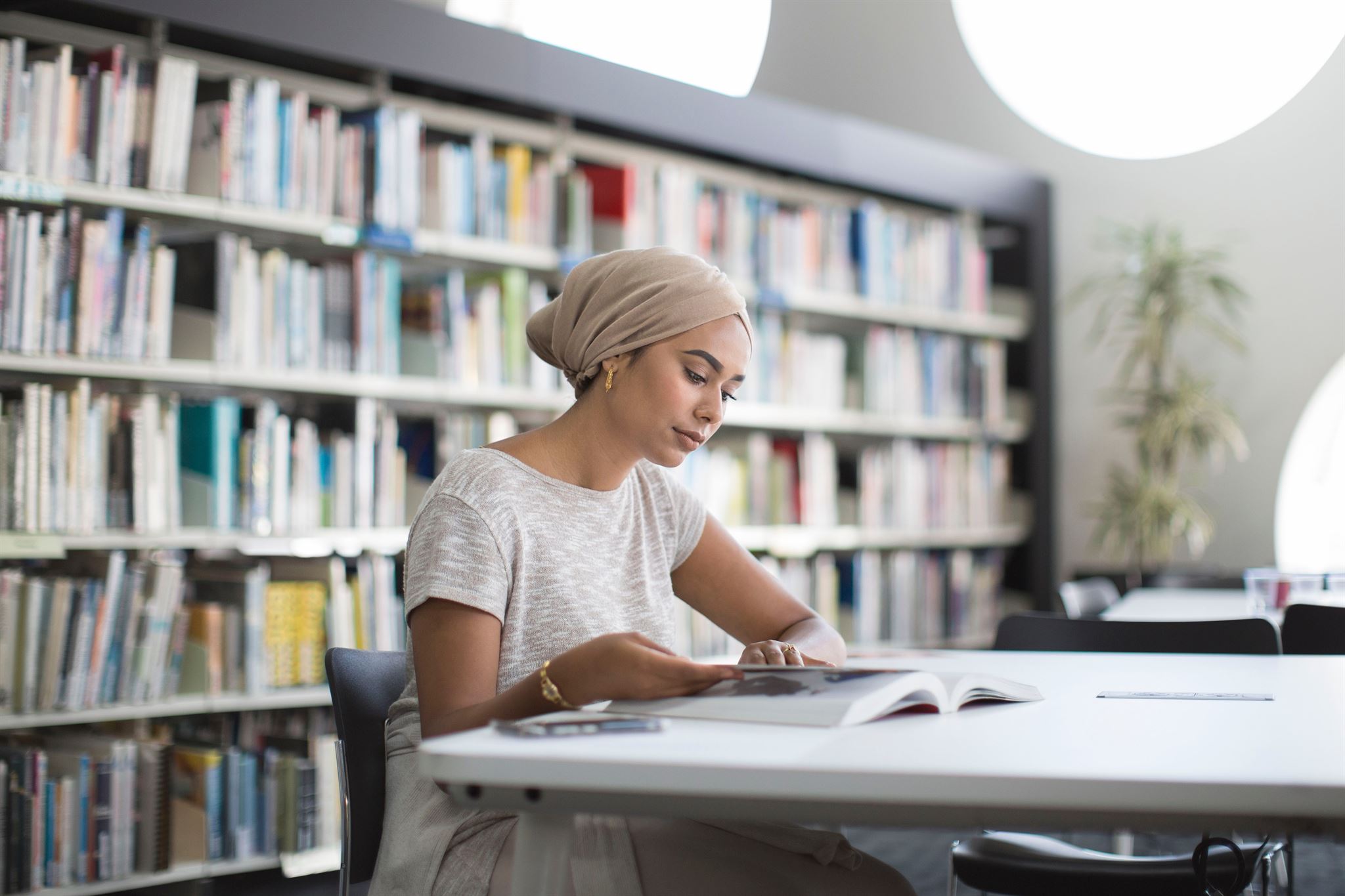 Woman-studying-book-in-library